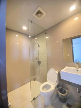 a bathroom with a toilet and a sink and a shower at Cozy 2br with pool and beach access in Punta Engaño