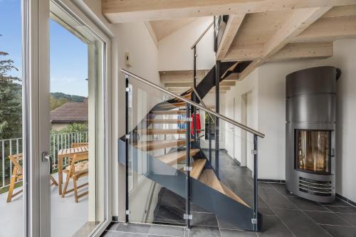a staircase in a house with a fireplace at Einzigartige Architekten-Wohnung in Winterthur in Brütten