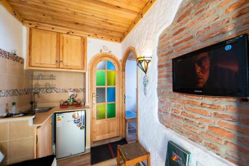 a kitchen with a tv on a brick wall at Casa panorama in Chefchaouene