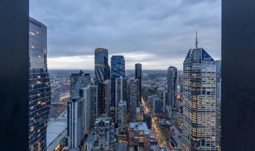 a view of a city with many tall buildings at Luxury Collins St Apartment- 2BR w Balcony- High Floor in Melbourne