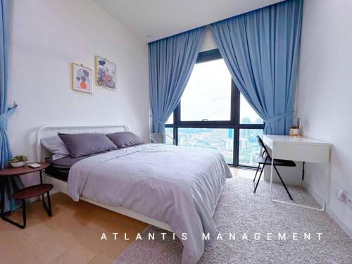 a bedroom with a bed and a desk and a window at Midvally Mega Mall, Link With The Garden, KL ECO City By Atlantis Management in Kuala Lumpur