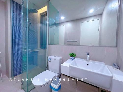 a bathroom with a toilet and a sink and a shower at Midvally Mega Mall, Link With The Garden, KL ECO City By Atlantis Management in Kuala Lumpur