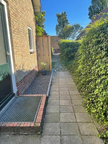 a walkway leading to a door of a house at De Cel in Nes