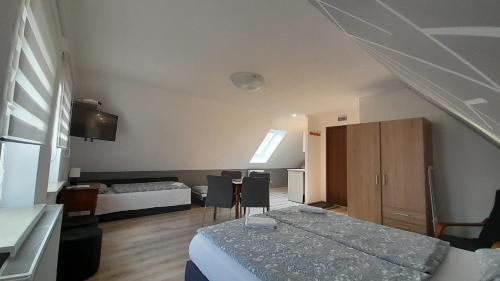 a bedroom with a bed and a room with a table at Apartament "Rodzinny zakątek" in Duszniki Zdrój