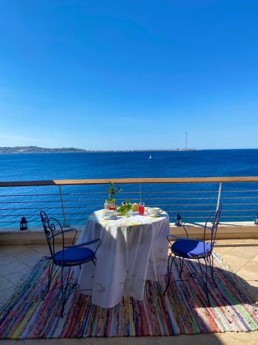 a table on a balcony with a view of the ocean at Blu Oltremare in Villa San Giovanni