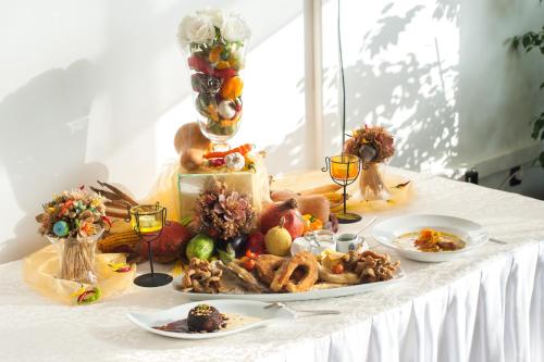 a table topped with plates of food and glasses of wine at ZOO hotel in Osijek