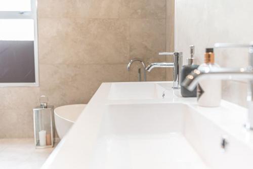 a bathroom with a sink and a bath tub at Luxury townhouse in Workington in Workington