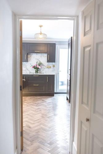 a hallway leading to a bathroom with a sink at Luxury townhouse in Workington in Workington