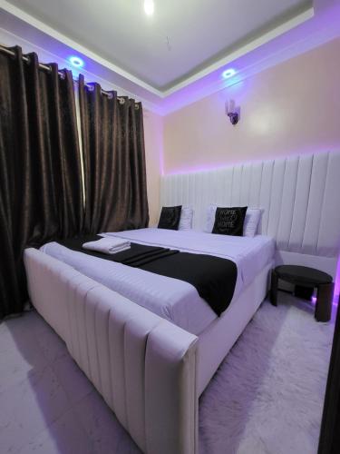 a bedroom with a large bed and a couch at G&G Homes Pioneer 2 Bedroom in Eldoret