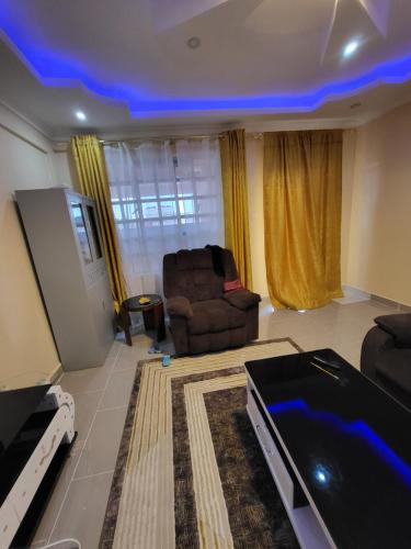 a living room with a couch and a chair at G&G Homes Pioneer 2 Bedroom in Eldoret
