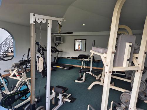 a gym with several treadmills and exercise bikes at Hotel Santo Tomas / Historical Property in San José