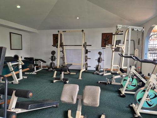 a gym with treadmills and exercise equipment on the floor at Hotel Santo Tomas / Historical Property in San José