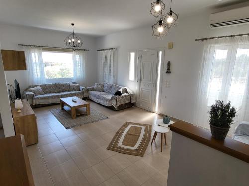 a living room with a couch and a table at Olive Τree Ηouses in Votsalákia