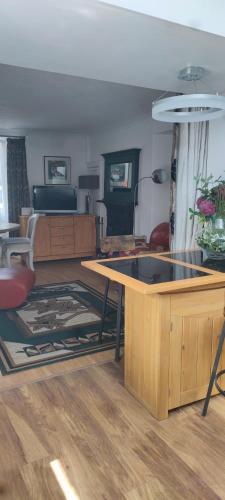 a kitchen with a table and a living room at Luxury house in Coldingham
