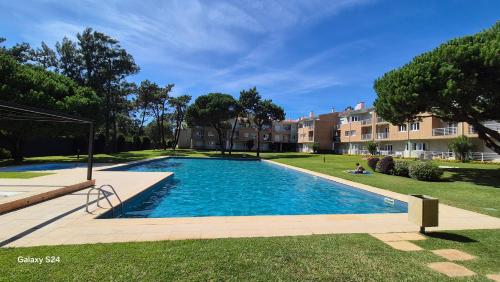 a large swimming pool in a yard with buildings at Casa Valérie in Esposende