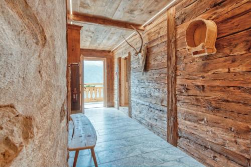 a room with a wooden wall and a chair at Finailhof in Madonna