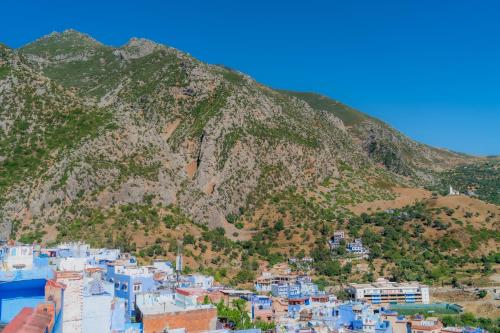 a view of a mountain with blue buildings at Casa panorama in Chefchaouene