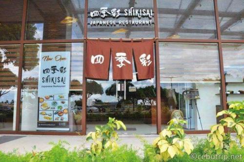 a window of a restaurant with a sign on it at Budget friendly 1bedroom in The Mactan Newtown with pool&beach access in Punta Engaño