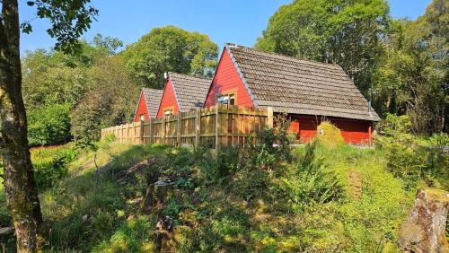 a row of red houses on a hill at Bunroy Park in Fort William