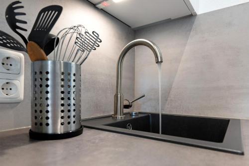 a kitchen counter with a sink and a knife holder at Ferienappartement Holm Ostsee in Brasilien