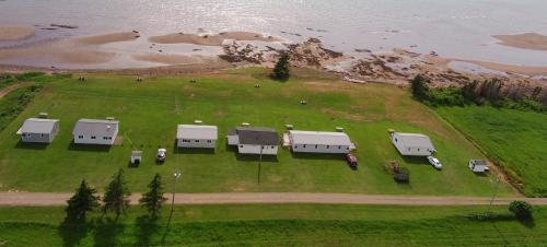 an aerial view of a group of trailers on a grass field at Cottages On PEI-Oceanfront in Bedeque