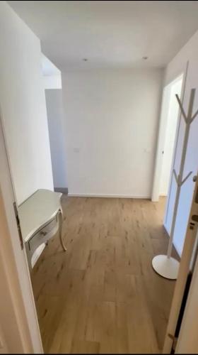 Habitación vacía con banco y suelo de madera en SUITE grassi, en Bresso