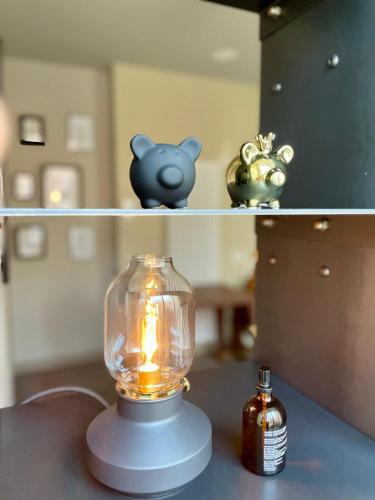 a glass jar with a candle on a shelf at STADLERINO - Tiny Loft in Venice in Marghera