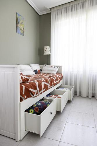 a bedroom with a bed with white drawers at Los Borgia in Viana