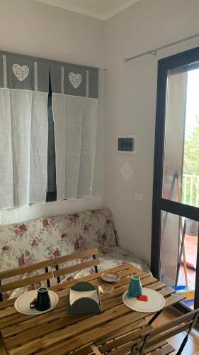 a living room with a wooden table and a couch at La Dolce Vita in Agnone Bagni