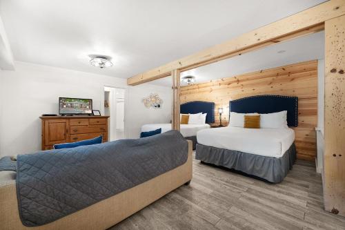 a hotel room with two beds and a couch at Inn on the Russian River in Monte Rio