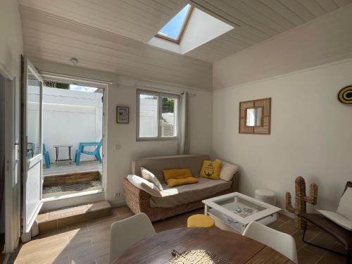a living room with a couch and a table at Pen Ty Armor maison de pêcheur proche mer au calme in Trébeurden
