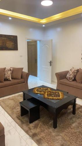 a living room with a couch and a coffee table at شقةارضية فاخرة مفروشة عمان ضاحية الرشيد in Ţāb Kirā‘