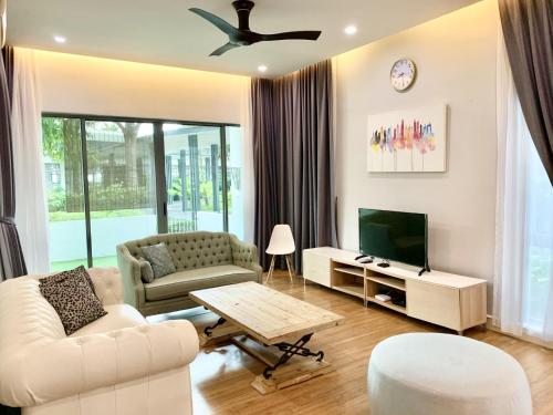 a living room with a couch and a tv at Deco Home @ Imago The Loft in Kota Kinabalu