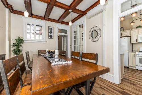 a kitchen and dining room with a wooden table at Masterpiece on Main 1 in Dubuque
