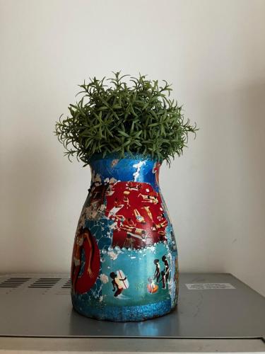 a colorful vase with a plant in it at Trouville Palace Le Bonheur in Trouville-sur-Mer