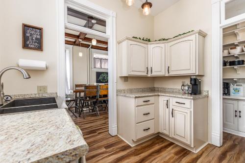 a kitchen with white cabinets and a counter top at Masterpiece on Main 1 in Dubuque