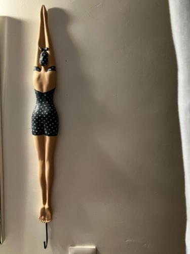 a mannequin is hanging on a wall at Trouville Palace Le Bonheur in Trouville-sur-Mer