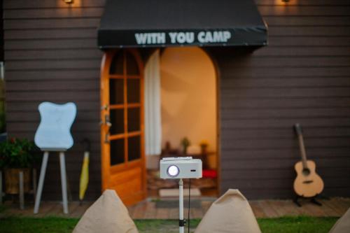 a house with a sign that reads with you clump at With you camp in Ban Kham Kom