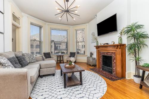 a living room with a couch and a fireplace at Masterpiece on Main 2 in Dubuque