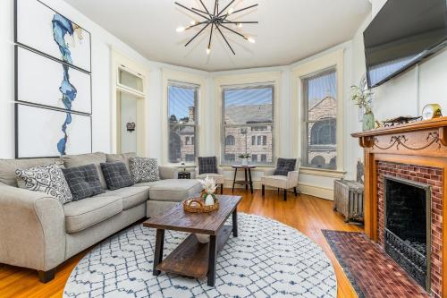 a living room with a couch and a fireplace at Masterpiece on Main 2 in Dubuque