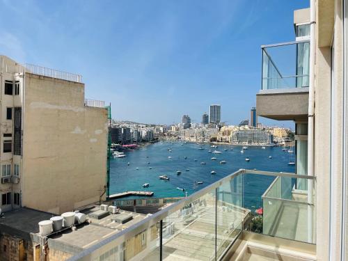 a view of a harbor from a balcony of a building at Duplex Penthouse in Sliema in Sliema