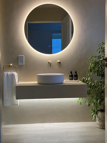 a bathroom with a sink and a mirror at Somerled House in Portree