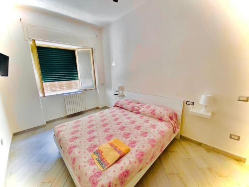 a bedroom with a bed in a room with a window at Essenza3 0 in Salerno