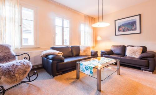 a living room with two couches and a coffee table at Ferienhaus Innerste in Wildemann
