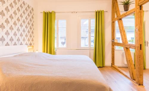 a bedroom with a bed and two windows at Ferienhaus Innerste in Wildemann