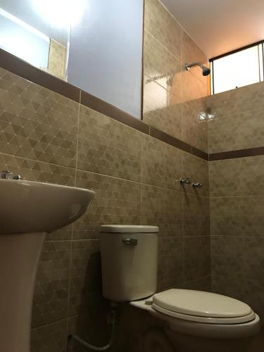 a bathroom with a toilet and a sink at Hospedaje D Francisco in Lima