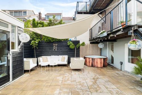 a patio with chairs and a table on a building at Chique Ibiza Zaandam in Zaandam