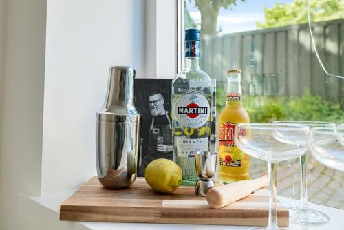 a table with two bottles of alcohol and wine glasses at Chique Ibiza Zaandam in Zaandam