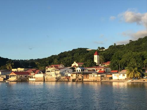 a town on the shore of a body of water at Villa Coco Caraïbes in Deshaies