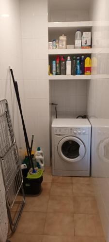 a laundry room with a washing machine and a washer at Marina in Lleida